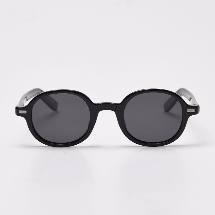 Round sunglasses with black frame and dark lenses on a white background
